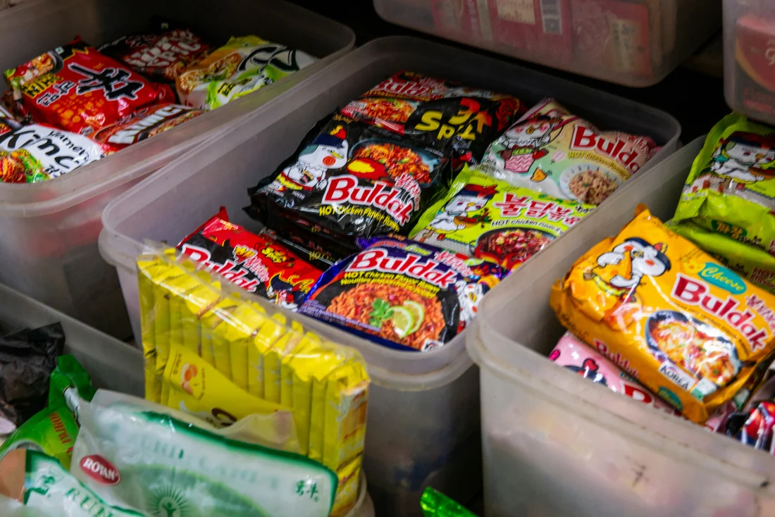 Instant noodle packets displayed in a retail store, shown as category examples